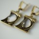 Brass earrings with a cat's eye stone ŽA181-2